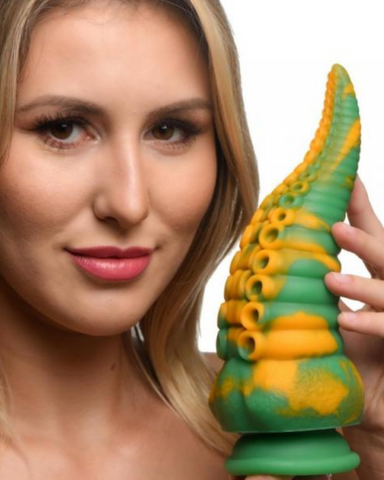 Monstropus Tentacled Monster 8.5 Inch Silicone Dildo being held by a model on a white background