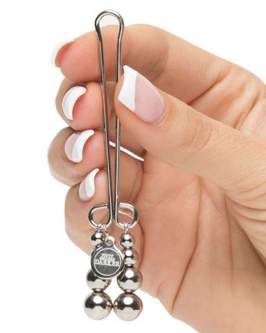 Hand holding Fifty Shades Darker Just Sensation Beaded Clitoral Clamp