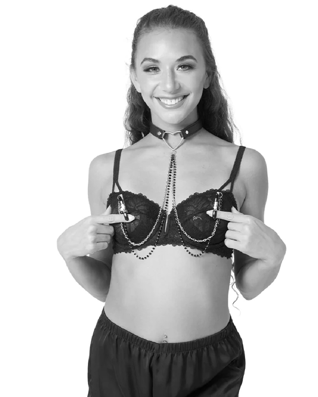 Black and white photo of model wearing Sex & Mischief Amor Heart Collar and Nipple Jewelry