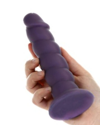 Fantasy Purple Unicorn Horn 7 Inch Silicone Dildo held in a hand on a white background